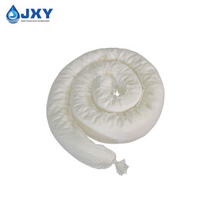 oil absorbent boom floating on water absorbing spilled oil