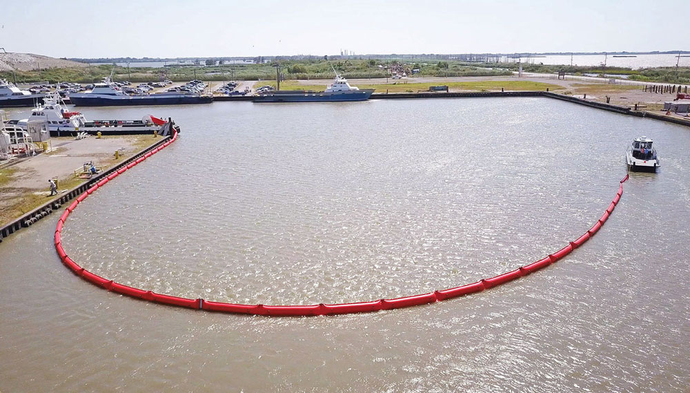 Oil containment boom deployed for marine oil spill response. Oil containment boom deployed for marine oil spill response.