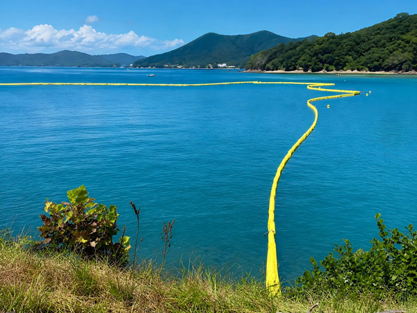 Permeable geotextile skirt material used for turbidity curtain sediment control